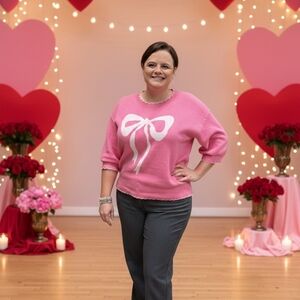 Pink Sweater with White Bow Design